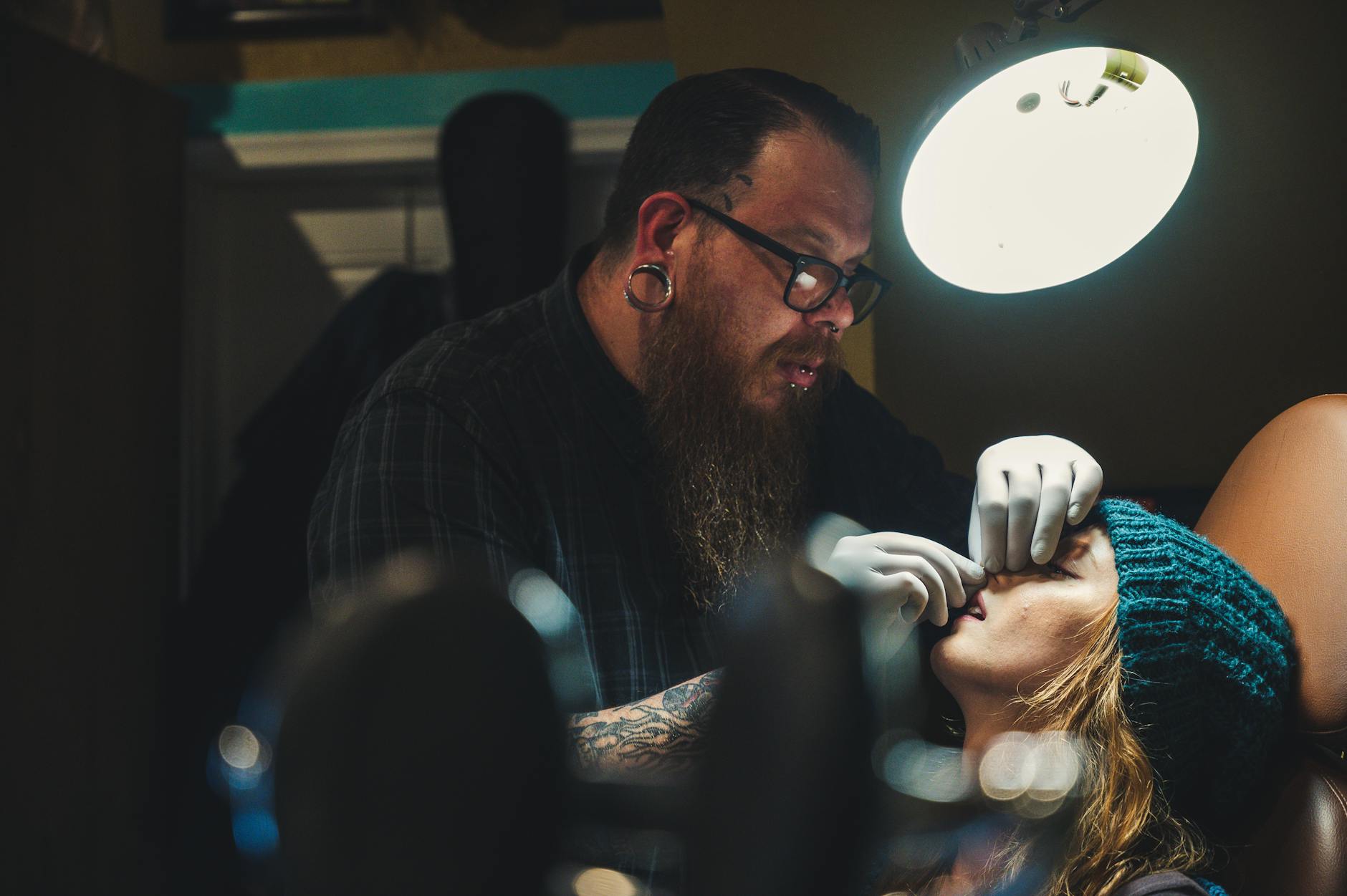 man piercing woman